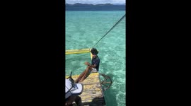 Filipino tour guide shows visitors how to strike a pose