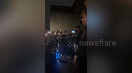 Woman has over 20 Christmas carol singers perform - in her kitchen
