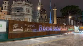 The slogan ‘Rome builds the future’ written on a fence of one of the construction sites of the C line in the evening in Rome.
