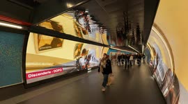 People walk along a stretch of the new corridor at the Spagna metro station where there are displays showing photos of the work done and the slogan ‘Rome Jubilee 2025’ in Rome.