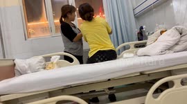 Child poses playfully on hospital bed in Inner Mongolia