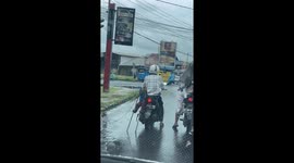 Monkey relaxes on motorbike at red light in Indonesia