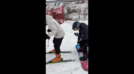 Two people create sleigh and slide on snow in Shandong