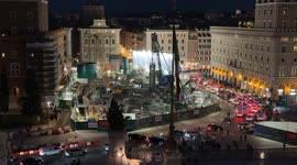 Evening traffic in Piazza Venezia around the construction site for the new Metro C stop in Rome.