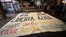 A large banner with the slogan ‘woman life freedom, from your mountains to our mountains’ placed on the ground during the demonstration called by the Kurdistan Italia Information Office with the slogan 'Defend Rojava' in Rome.