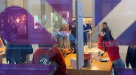 The interior of a store of a famous chain of technological devices with many customers inside during the Christmas period in Rome.
