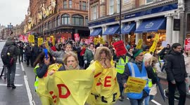 Noisy workers march from Harrods to the Science Museum in London in connection with the pre-Christmas strike