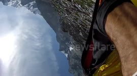 Awesome wingsuit proximity flying BASE jump with Douggs hand camera angle