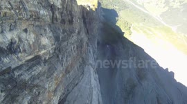 Big wall BASE jump flying through new crack Douggs POV camera angle sunny day