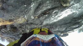 Douggs jumps dangerous cliff BASE jump with head facing camera in winter