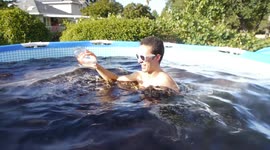 Taking a bath in a giant 1,500 gallon Coca-Cola swimming pool