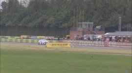 Race Car Skids Off Road Into Tyres