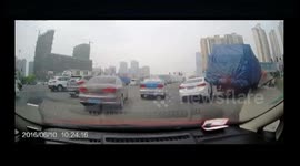 Lorry turning a corner drags a car away