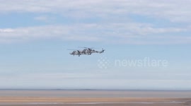 Helicopters fly backwards at Armed Forces Day in Cleethorpes, UK
