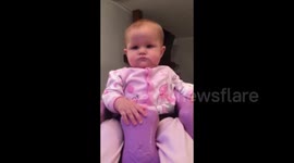 Baby 'head bangs' to music