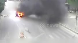 Car stopped at red light bursts into flames