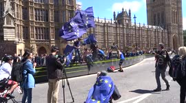 March for Europe participants fly EU flags outside Parliament