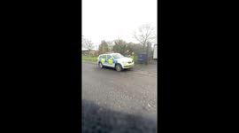 Motorbike rider throws dirt on police vehicle in Belfast, Ireland