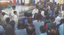 Priest accidentally splashes a large amount of holy water on a person in Manila, Philippines