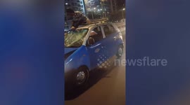 Taxi driver speeds away with 'hit-and-run victim sitting on roof'
