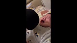 Adorable baby reacts in surprise to the sound of its own cry