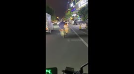 Chinese man rides motorcycle with baby in sidecar