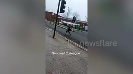 Shocking moment youths chase each other with machetes outside college