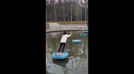 Girl falls into water on Ninja Warrior course in park