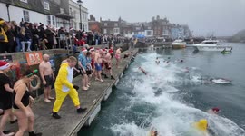 Thousands Watch Christmas Day Morning Harbour Swim in Weymouth Dorset UK