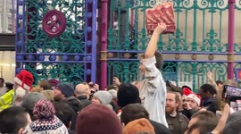 Crowds attend the Christmas Meat Auction at Smithfield Market in the City of London