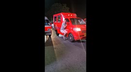 Tipsy tourist bizarrely clings to side of tuktuk bus