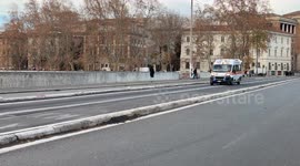 An ambulance speeds down the road with sirens blaring on Christmas Day in Rome