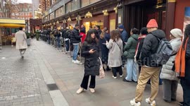 Very long queues outside Harrods store in Knightsbridge, London as people rush to shop for Boxing Day sales