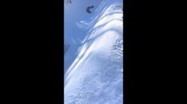 Holidaymakers enjoy snowy ride slide in mountain