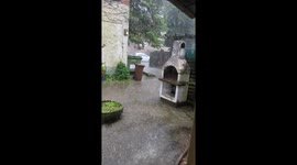 Pouring rain from outside a front door of an apartment building in Hanover, Germany