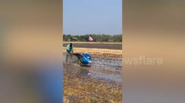 Farmers compete in tractor racing on paddy field in Thailand