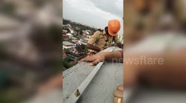 Daring rope rescue: Firefighters save woman trapped in kitchen for hours