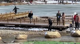 Tourist slips on boulder after failing to jump onto it