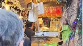 Customers line up inside an old delicatessen in the historic center on a Sunday in December during the Christmas period in Rome.