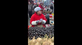 Skilled vendor peels water chestnuts without looking in China