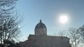 Birds flutter around the dome of a church on a sunny late December morning in one of the suburbs of Rome.
