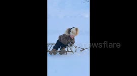 3-Year-Old Enjoys Snowy Adventure with Dad in Remote Xinjiang Village