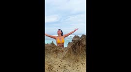 Bikini beach video goes wrong when wave slams into posing girl