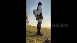 China: A Cat Interrupt a Girl’s Best Photo Posture