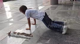 China: A Girl Mimics a Cat’s Sleeping Posture