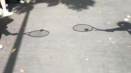 China: The shadow of keeping a tennis ball rolling along the edge of a tennis racket