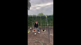 Man Pushes Chickens On Playground Swings