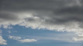 30 second time lapse of dark clouds moving in over white clouds.