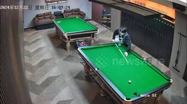 Man falls after attempting tricky billiards shot in Zhejiang, China