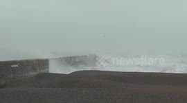Rough seas batter Newhaven sea arm on New Years Day in Sussex, UK